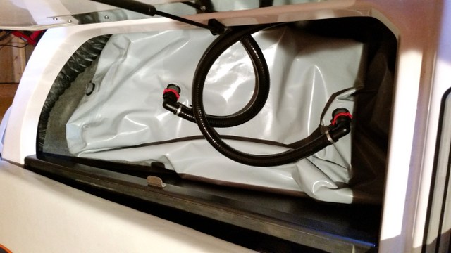 Bag on top of hard tank, fill and drain hoses with quick disconnects, hose length allows for expansion of bag when full